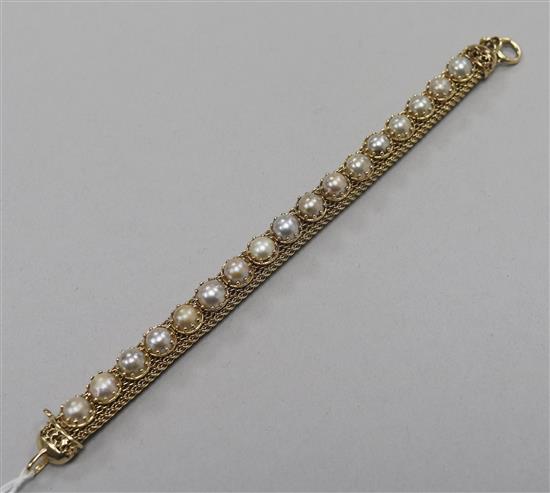 A yellow metal and split pearl set cagework line bracelet. 17.5cm.